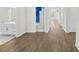 Long hallway with light wood flooring and access to rooms at 8852 Prairie Creek Dr, New Port Richey, FL 34655