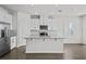 Modern kitchen with white cabinets, granite countertops, and island at 8852 Prairie Creek Dr, New Port Richey, FL 34655