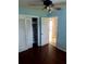 Bedroom with wood floors, built-in closet and access to hallway at 1004 E Fern St, Tampa, FL 33604