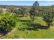Aerial view of land with mature trees and a grassy area at 1810 Curry Rd, Lutz, FL 33549