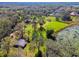 Aerial view showing a house and expansive lot with lake access at 1810 Curry Rd, Lutz, FL 33549