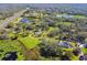 Aerial view of property with pond, home and highway access at 1810 Curry Rd, Lutz, FL 33549