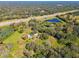 Aerial view of property with pond and highway access at 1810 Curry Rd, Lutz, FL 33549