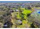 Aerial view of property showing two homes and a pond at 1810 Curry Rd, Lutz, FL 33549
