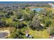 Aerial view of property showing home, land, and pond at 1810 Curry Rd, Lutz, FL 33549