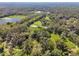 Aerial view of property showing home, land, and pond at 1810 Curry Rd, Lutz, FL 33549