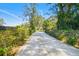 Driveway entrance with a gated community at 1810 Curry Rd, Lutz, FL 33549