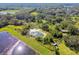 Aerial view of property with pond and mobile home at 1810 Curry Rd, Lutz, FL 33549