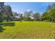 Large lot with a small house in the background at 1810 Curry Rd, Lutz, FL 33549