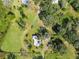 Aerial view of property showcasing a house and surrounding land at 1810 Curry Rd, Lutz, FL 33549