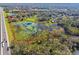 Aerial view of property highlighting wetland area and road at 1810 Curry Rd, Lutz, FL 33549