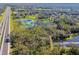 Aerial view of property with pond and highway access at 1810 Curry Rd, Lutz, FL 33549