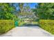 Ornate green gate leading to a charming property at 1810 Curry Rd, Lutz, FL 33549