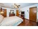 Bedroom with hardwood floors, large bed, and ensuite bathroom at 2025 Macarthur Ct, Dunedin, FL 34698