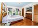 Cozy bedroom with wood floors, a double bed, and ample closet space at 2025 Macarthur Ct, Dunedin, FL 34698