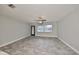 Living room with tile flooring, ceiling fan, and a door leading to the backyard at 664 Frederica Ln, Dunedin, FL 34698