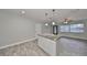 Bright kitchen with white cabinets, granite countertops, and a view of the dining area at 664 Frederica Ln, Dunedin, FL 34698