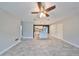 Open-concept living area with tile flooring, ceiling fan, and view of the kitchen at 664 Frederica Ln, Dunedin, FL 34698