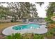 In-ground pool with surrounding patio and tropical landscaping at 664 Frederica Ln, Dunedin, FL 34698