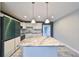 Modern kitchen featuring white cabinetry, granite countertops, and stainless steel appliances at 664 Frederica Ln, Dunedin, FL 34698