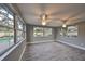 Florida room with large windows offering views of the backyard pool at 664 Frederica Ln, Dunedin, FL 34698