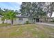 Charming single-story home with a landscaped front yard and attached garage at 664 Frederica Ln, Dunedin, FL 34698
