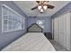 Blue bedroom with ceiling fan, and closet with white doors at 664 Frederica Ln, Dunedin, FL 34698