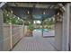 Backyard deck with a pergola, string lights, and a view of the pool at 664 Frederica Ln, Dunedin, FL 34698