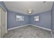 Spacious bedroom with wood-look tile floors and updated windows at 664 Frederica Ln, Dunedin, FL 34698