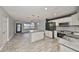 Kitchen with island, white cabinetry, and an open view to the adjacent living area at 664 Frederica Ln, Dunedin, FL 34698