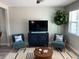 Living area featuring teal armchairs, a wood coffee table, and large TV at 2658 48Th S St, Gulfport, FL 33711