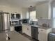 Newly renovated kitchen with white cabinets, stainless steel appliances, and gray countertops at 2658 48Th S St, Gulfport, FL 33711