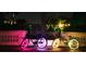 Two bikes with LED wheel lights are parked at night by a canal at 2658 48Th S St, Gulfport, FL 33711