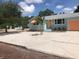 Charming teal home with a gravel driveway and mature trees at 2658 48Th S St, Gulfport, FL 33711