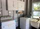 Bright laundry room with washer, dryer, and storage cabinets at 2658 48Th S St, Gulfport, FL 33711