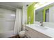 Charming bathroom with green walls and white vanity at 1960 Lakewood Club Dr S # 2-F, St Petersburg, FL 33712