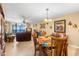 Spacious dining area with wooden table and chairs, overlooking living room and ocean view at 14900 Gulf Blvd # 410, Madeira Beach, FL 33708