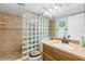 Bathroom with glass block shower and updated vanity at 14900 Gulf Blvd # 410, Madeira Beach, FL 33708