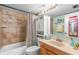 Guest bathroom with tub shower and updated vanity at 14900 Gulf Blvd # 410, Madeira Beach, FL 33708