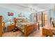 Bright main bedroom with a wooden bed frame and ocean view at 14900 Gulf Blvd # 410, Madeira Beach, FL 33708