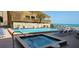 Community pool and spa area with lounge chairs, offering resort-style amenities at 14900 Gulf Blvd # 410, Madeira Beach, FL 33708