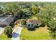 Bird's-eye view of a yellow house with a green lawn, located near a lake at 2539 Shadecrest Rd, Land O Lakes, FL 34639