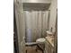 Bathroom features a shower with a patterned curtain, toilet, and vanity at 3102 W Leroy St # A, Tampa, FL 33607