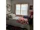 Bedroom with a full bed, bright window, and personal decor at 3102 W Leroy St # A, Tampa, FL 33607