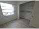 Bedroom featuring light colored wood flooring, bright white walls and closet with shelving at 3102 W Leroy St # A, Tampa, FL 33607