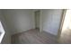 Bedroom featuring light colored wood flooring, bright white walls and closet with shelving at 3102 W Leroy St # A, Tampa, FL 33607