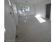Bright living room with light-colored floors, a window and white walls at 3102 W Leroy St # A, Tampa, FL 33607