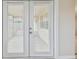 Close-up view of the double doors that lead to a tiled outdoor patio space at 3525 Umber Rd, Holiday, FL 34691