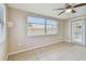 Bright sunroom with tile flooring, ceiling fan, large windows and access to the outdoors at 3525 Umber Rd, Holiday, FL 34691