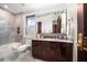 Bathroom with dark wood vanity, marble countertop and shower at 429 Saint Andrews Dr, Belleair, FL 33756